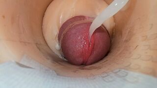 Camera explores wet slit as thick load erupts inside