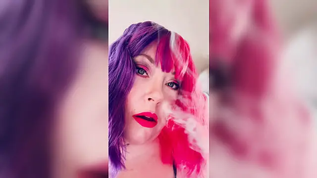 Chubby Cougar Tina Snua Lights Up A Cork Tipped Cig In Latex Gloves